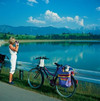 Woman with binoculars at lake Premer Lechsee with Allgu Alps