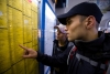 Dresden: young man consulting timetable at railway station; Copyright: DZT, Photo by B. Haenssler