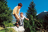 Father and son are hiking in the mountains