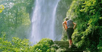 Walker with a waterfall in the background