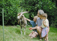 Man with two children and a goat