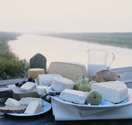 Grapes, apples, bread and milk complement this heavenly cheeseboard