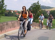Friends enjoy a cycling tour through the Tauber Valley