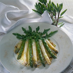 Mouthwatering dish of white and green asparagus spears garnished with rocket