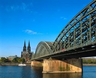 Cologne's majestic cathedral with the Hohenzollern bridge and the Rhine in the foreground