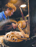 Woodturner crafting a wooden animal