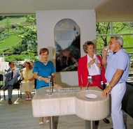 Couple enjoy mineral water fresh from the spring at Bad Teinach