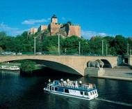 Pleasure boat with Romanesque church in the background