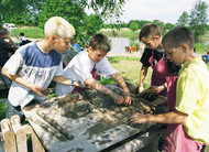 Children make their own pottery outdoors