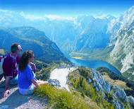 Walkers enjoying panoramic view of the mountains and lake