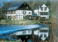 Timber-framed grinding mill by a river