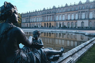 The inner courtyard of Herrenchiemsee Palace with the statue of a sitting woman by the fountain