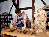 Man carving wooden figures