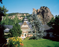House in front of bizarre rock formation in Bad Münster am Stein