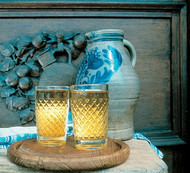 Two full cider glasses with traditional jug