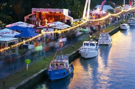 Illuminated stalls and boats along the museum embankment in Frankfurt am Main