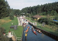 Canoes and boats at a lock on a waterway