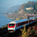 An intercity train speeds along the Rhine