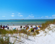 Sand dunes and wicker beach chairs on a North Sea beach