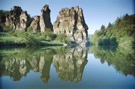 The strange Externsteine rocks reflected in a lake