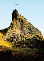 View of the Druid's Stone cultural monument with a cross on the top