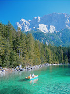 Boat on Eibsee lake with the Zugspitze in the background