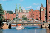 View of the brick buildings in the warehouse district with bridge and boat