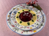 Plate of red fruit compote with vanilla sauce