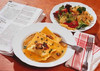 Plate of Maultaschen in a thin soup and salad side-plate