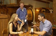 Young couple at a wine tasting in the wine grower's cellar